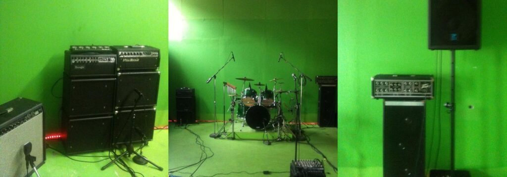 Panorama of the studio: amp stacks, the drum kit and the PA