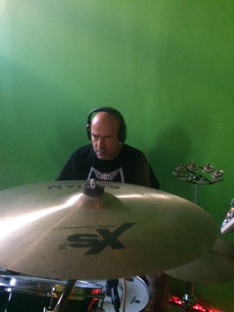 Drummer in headphones behind a Sabian cymbal