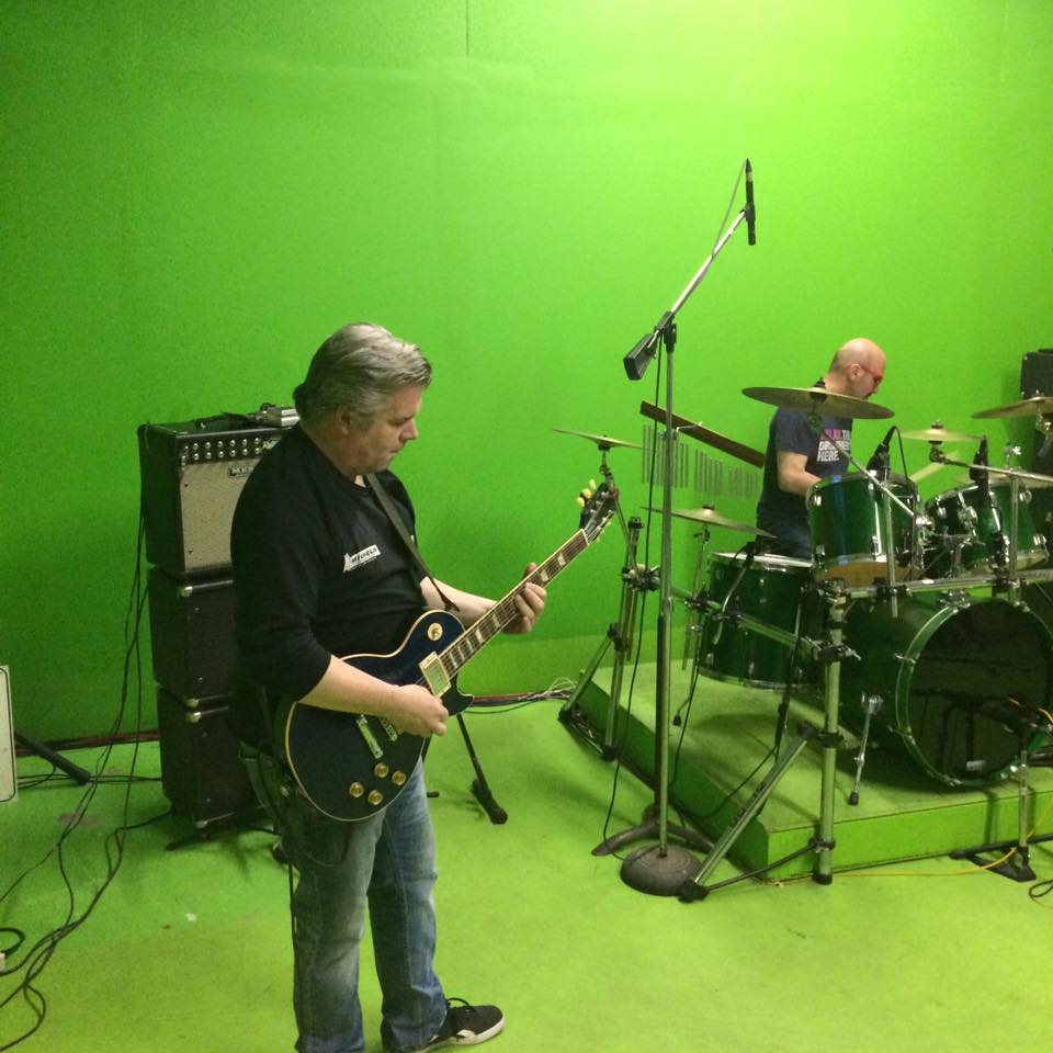 Guitarist and drummer playing live in the green room