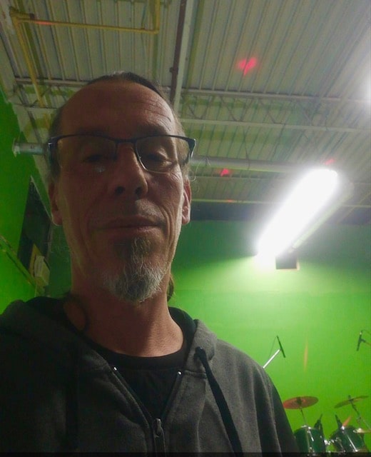 Selfie in the studio hallway under fluorescent lights